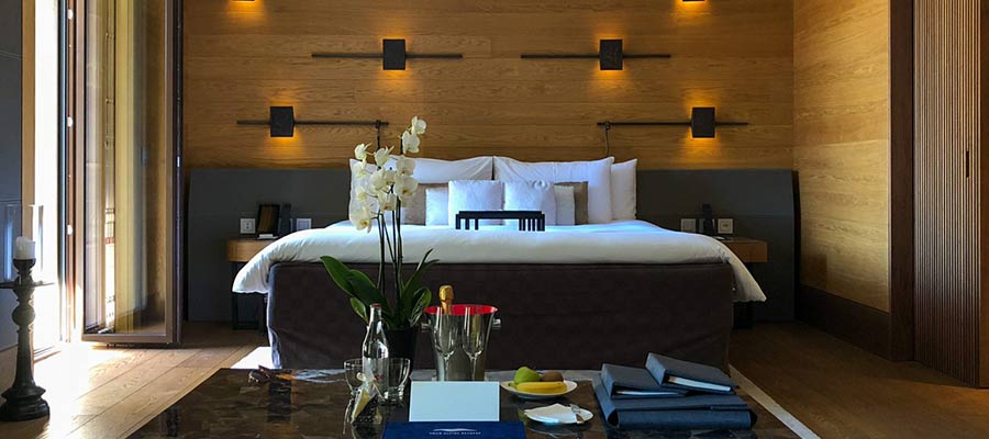 Reference hotel room showing planned headboard, bedside lighting and timber joinery